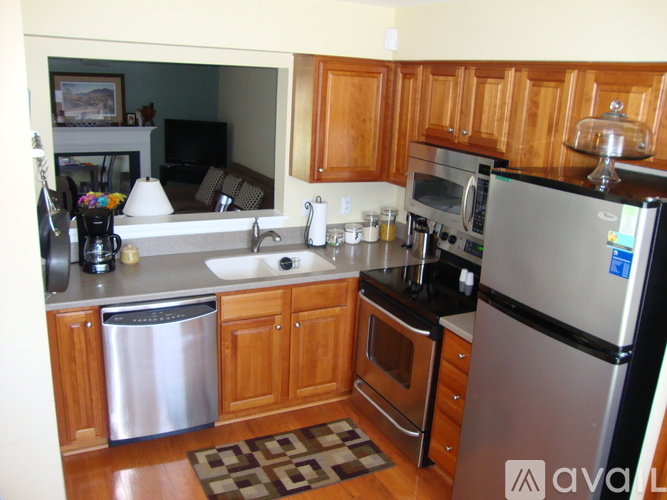 A kitchen with wooden cabinets and stainless steel appliances.