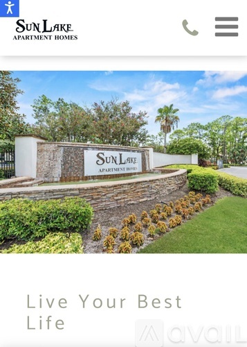 A sign that says Sun Lake Apartment Homes in front of a building.
