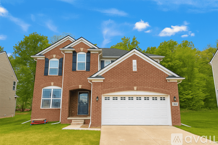 A brick house with a white garage door and a black door.