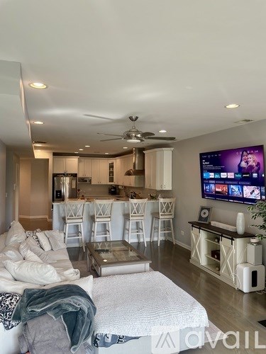 A living room with a television and a couch.