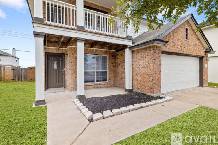 A house with a brick facade and a white porch.