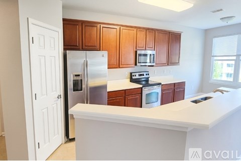 A kitchen with wooden cabinets and stainless steel appliances.
