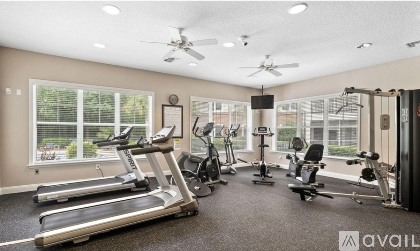 A well-equipped gym with treadmills, exercise bikes, and other workout machines.
