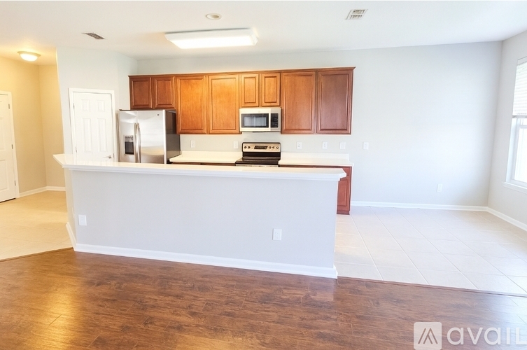 A kitchen with wooden cabinets and a white countertop.