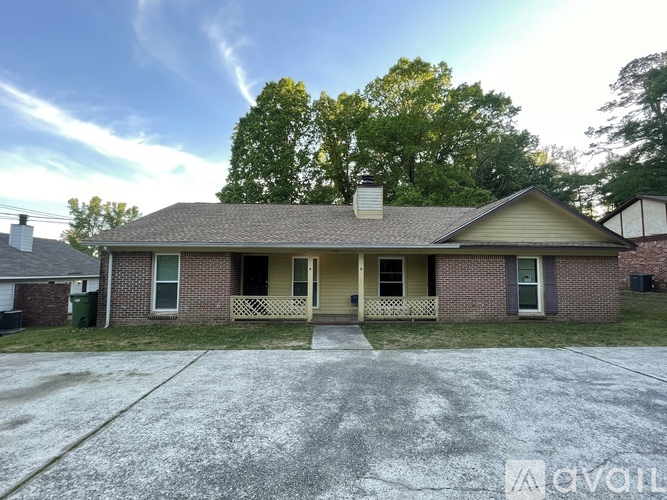 A house with a front porch and a driveway in front.