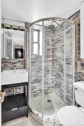 A bathroom with a walk in shower and a toilet.