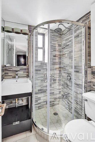 A bathroom with a walk in shower and a toilet.