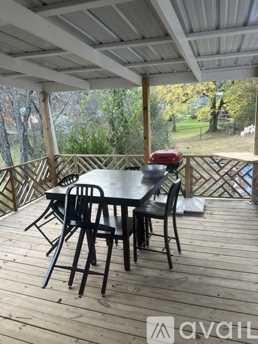 A wooden deck with a table and chairs.