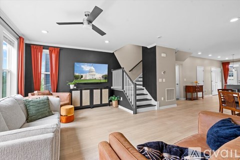 A living room with a grey couch and a television.