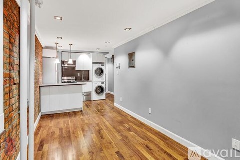 A kitchen with a washer and dryer in a laundry room.