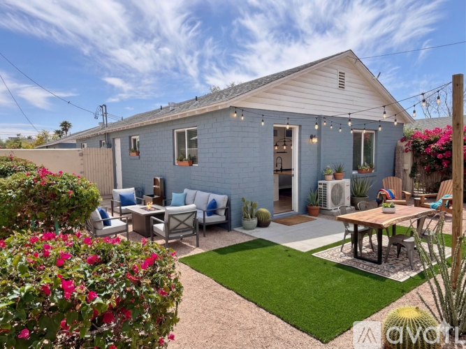 A blue house with a patio and a table.