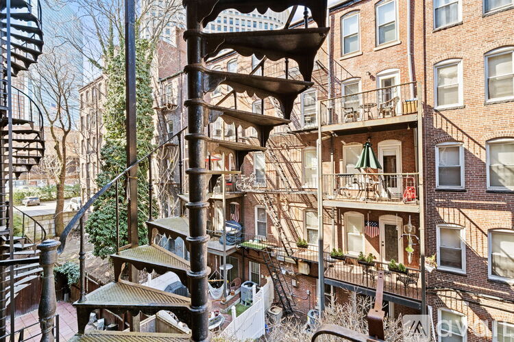 A multi-story building with a fire escape on the side.