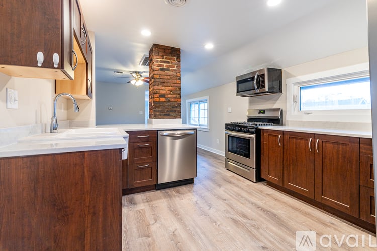 A kitchen with wooden cabinets and a brick chimney.
