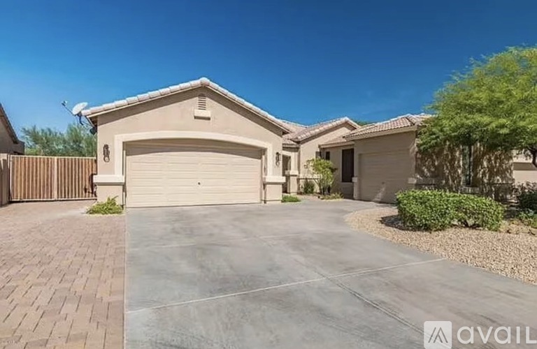 A house with a garage and driveway in front of it.