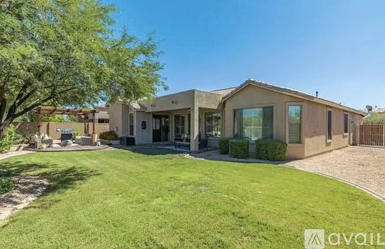 A modern house with a large front yard.