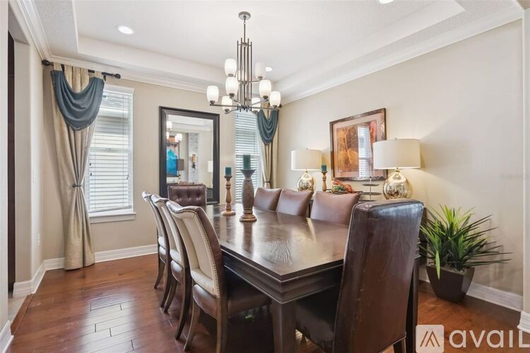 A dining room with a wooden table and chairs.