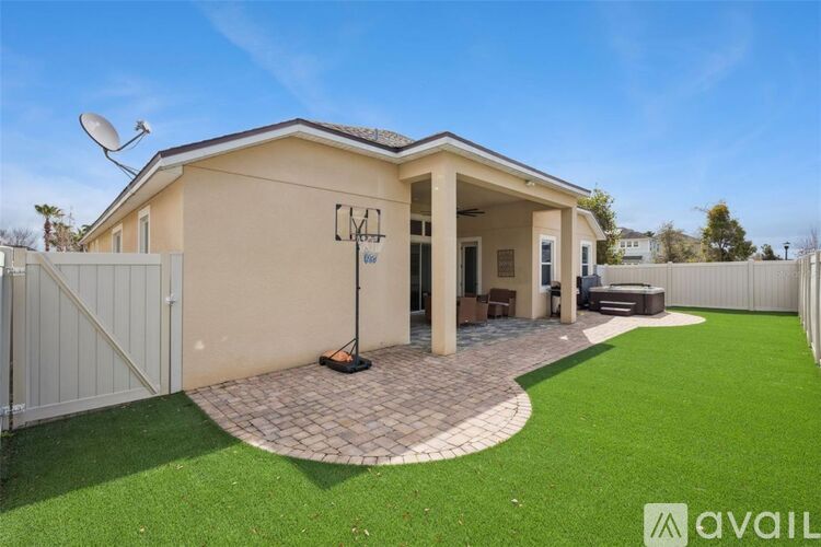 A house with a beige exterior and a white fence is for sale.
