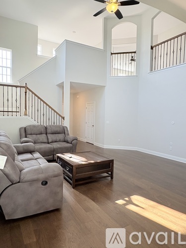 A living room with a grey sofa and a wooden coffee table.