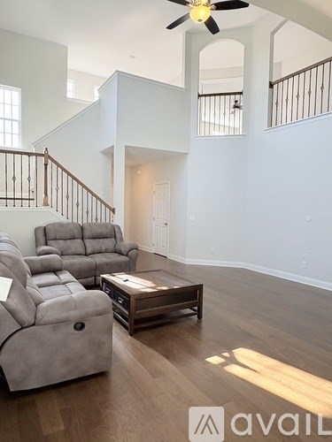 A living room with a grey sofa and a wooden coffee table.