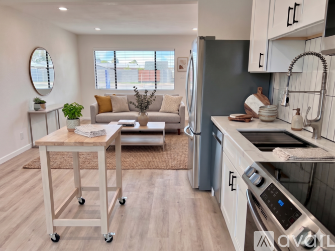 A modern kitchen with a table and chairs in the middle of the room.