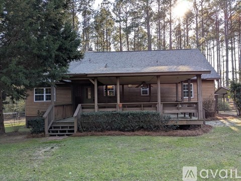 A house with a porch and a front yard.