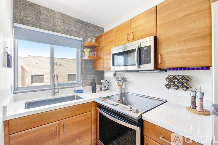 A kitchen with wooden cabinets and a stainless steel oven.