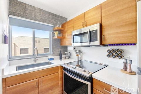 A kitchen with wooden cabinets and a stainless steel oven.