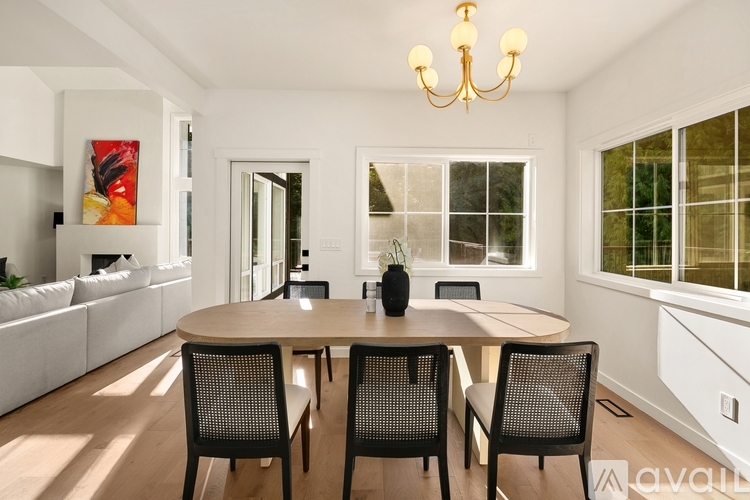 A dining room with a round table and chairs.