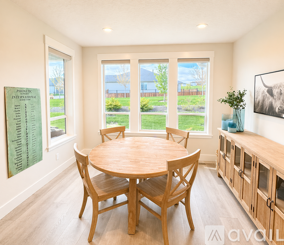 A dining room with a wooden table and chairs.