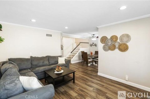 A living room with a grey sofa and a coffee table.