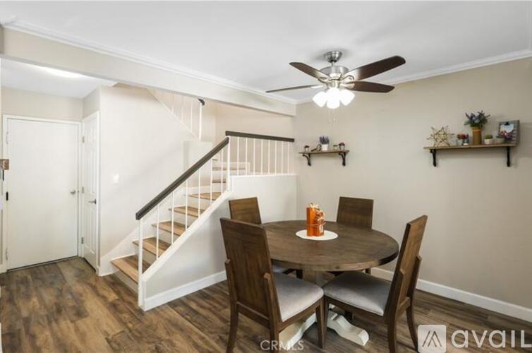 A dining room with a round table and chairs.