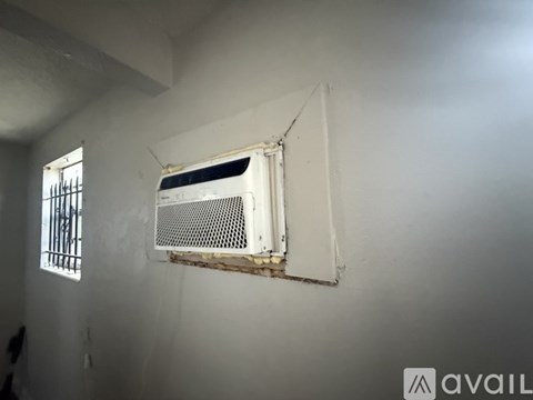 A room with wooden flooring and white walls.