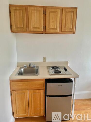 A kitchen with wooden cabinets and a stove top oven.