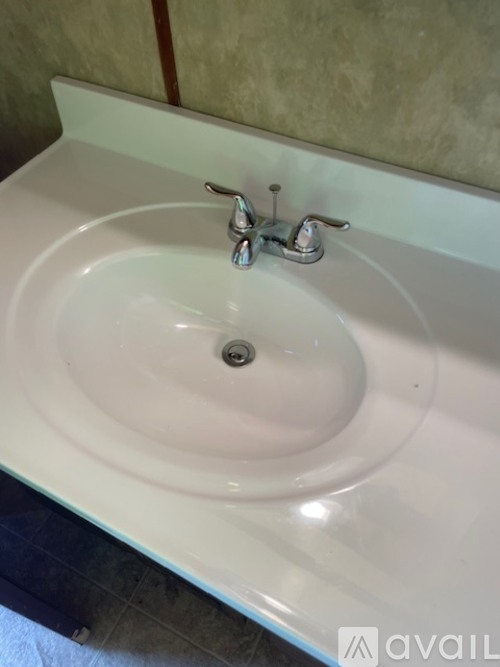 A white bathroom sink with a silver faucet.