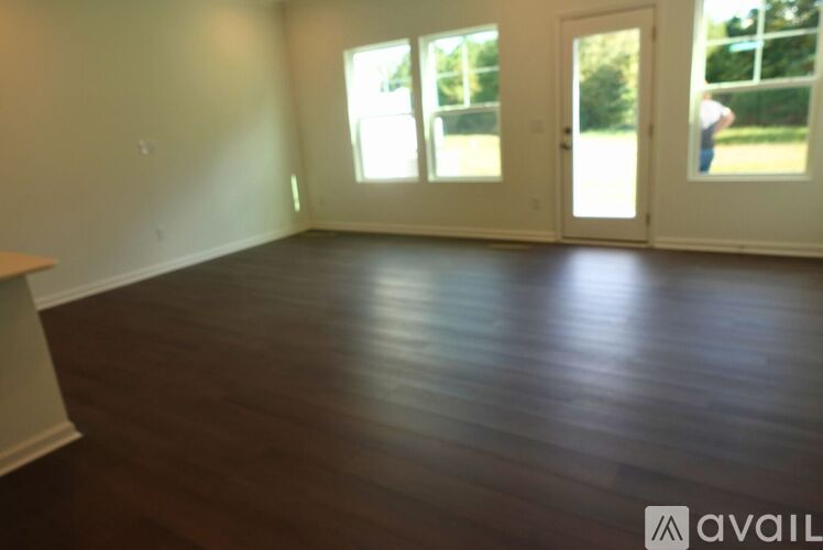 A room with wooden floors and white walls.