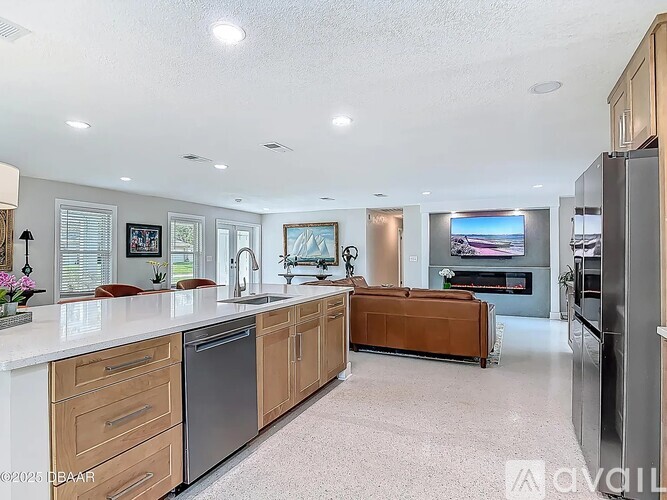 A modern kitchen with wooden cabinets and stainless steel appliances.