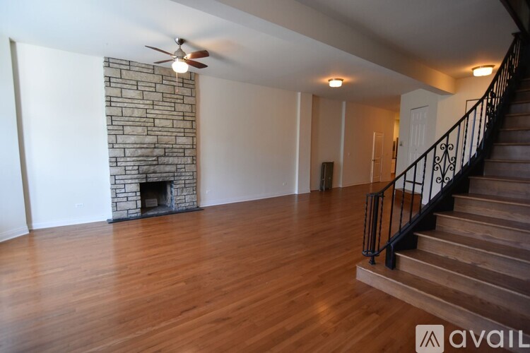 A room with a fireplace and wooden floors.