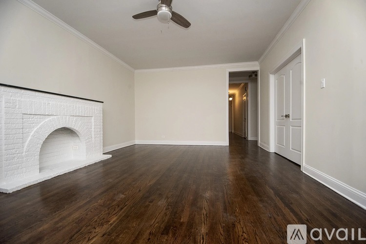 A room with a fireplace and wooden floors.