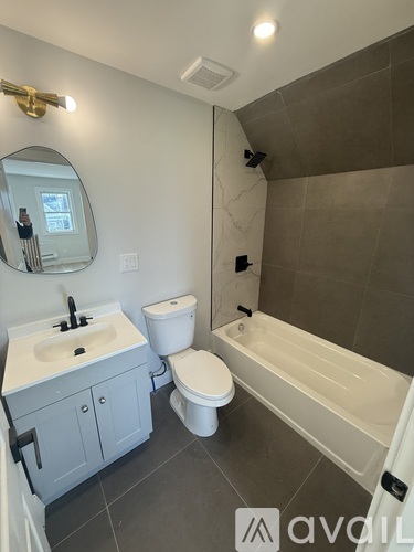 A bathroom with a sink, toilet, and bathtub.