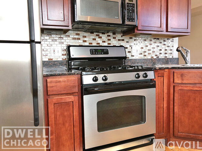 A kitchen with a stove top oven and a microwave above it.