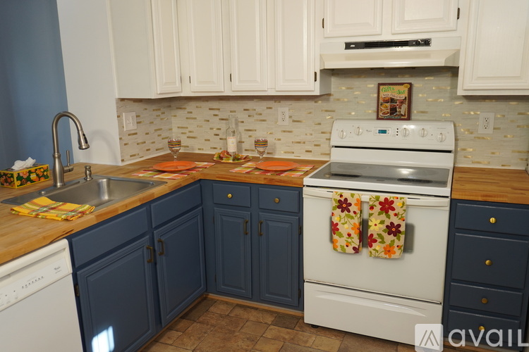 A kitchen with a white oven and blue cabinets.
