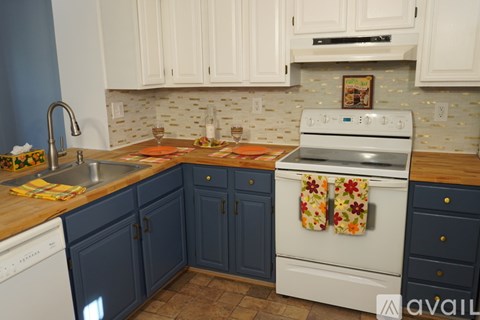 A kitchen with a white oven and blue cabinets.