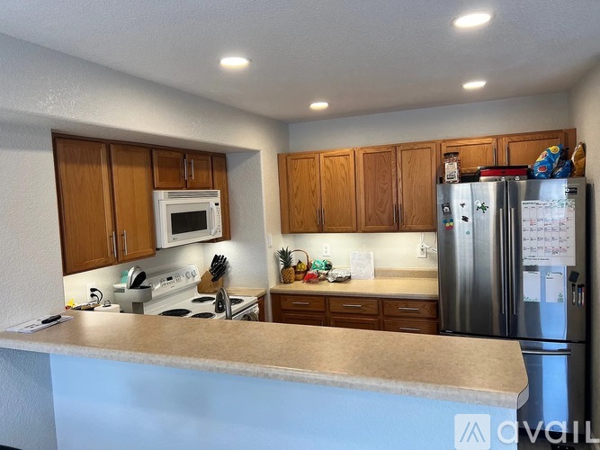 A kitchen with wooden cabinets and stainless steel appliances.