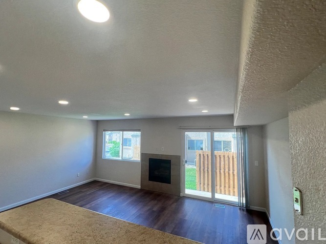 A living room with a fireplace and sliding glass doors.