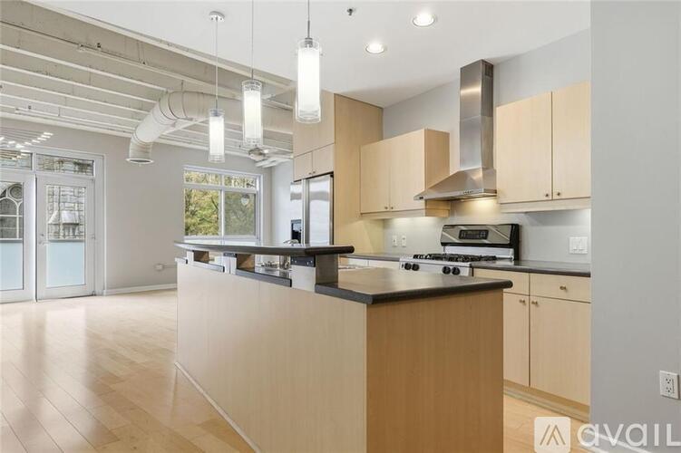 A modern kitchen with wooden cabinets and a central island.