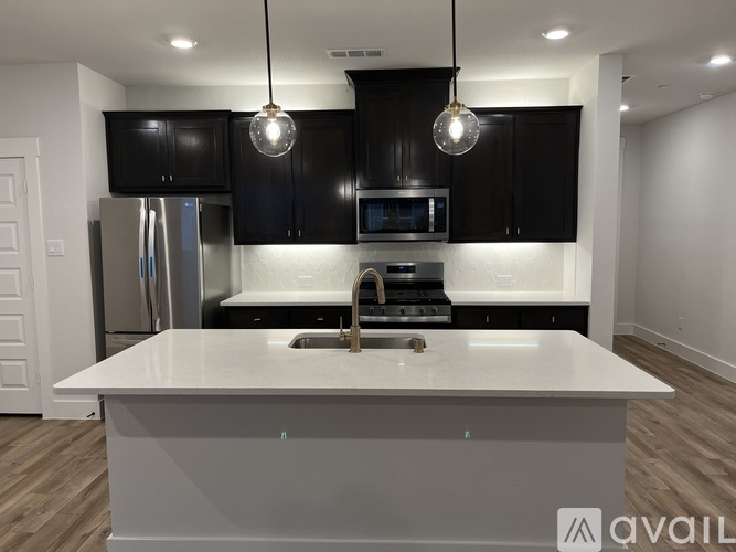 A modern kitchen with a large island in the center.