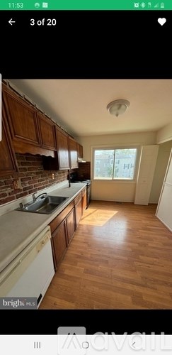 A kitchen with wooden cabinets and a white countertop.