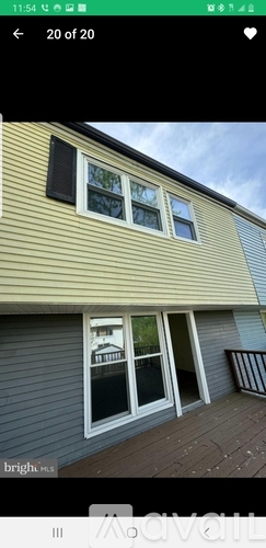 A house with a grey siding and a yellow wall.