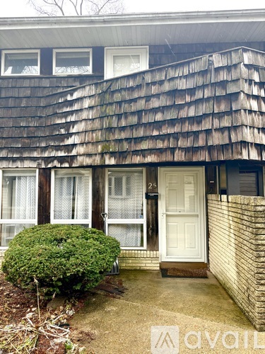A house with a white door and a brown roof.