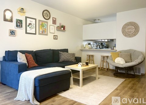 A living room with a blue couch and a white coffee table.